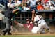 Jun 15, 2013; Omaha, NE, USA; Oregon State Beavers catcher Jake Rodriguez (13) misses the ball as Mississippi State Bulldogs runner Hunter Renfroe (34) scores in the eighth inning during the College World Series game at TD Ameritrade Park. Mississippi State won 5-4. Mandatory Credit: Bruce Thorson-USA TODAY Sports