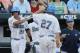 Jun 21, 2013; Omaha, NE, USA; UCLA Bruins center fielder Brian Carroll (24) congratulates first baseman Pat Gallagher (27) after he scored a run against the North Carolina Tar Heels during the College World Series game at TD Ameritrade Park. Mandatory Credit: Bruce Thorson-USA TODAY Sports