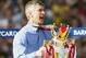 HIGHBURY, LONDON - MAY 15: Manager Arsene Wenger of Arsenal lifts the Premiership trophy during the FA Barclaycard Premiership match between Arsenal and Leicester City at Highbury on May 15, 2004 in London. (Photo by Clive Mason/Getty Images)