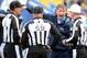 Norv Turner asks a group of officials for clarification on a ruling.