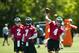 Jun 4, 2013; Philadelphia, PA, USA; Philadelphia Eagles quarterback GJ Kinne (4) passes the ball as fourth round draft pick quarterback Matt Barkley (2) and quarterback Michael Vick (7) look on during minicamp at the NovaCare Complex. Mandatory Credit: Howard Smith-USA TODAY Sports