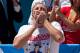NEW YORK, NY - JULY 04: Competitive eater Joey Chestnut competes in the Nathan's Famous International Hot Dog Eating Contest at Coney Island on July 4, 2012 in the Brooklyn borough of New York City. Chestnut won the men's division by successfully tying his own world record by eating 68 hot dogs in 10 minutes. (Photo by Andrew Burton/Getty Images)
