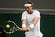 LONDON, ENGLAND - JUNE 24: Rafael Nadal of Spain plays a backhand during his Gentlemen's Singles first round match against Steve Darcis of Belgium on day one of the Wimbledon Lawn Tennis Championships at the All England Lawn Tennis and Croquet Club on June 24, 2013 in London, England. (Photo by Mike Hewitt/Getty Images)