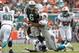 MIAMI GARDENS, FL - SEPTEMBER 23: Jared Odrick #98 of the Miami Dolphins hits Mark Sanchez #6 of the New York Jets as he gets the ball away on September 23, 2012 at Sun Life Stadium in Miami Gardens, Florida. (Photo by Joel Auerbach/Getty Images)