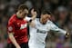 MADRID, SPAIN - FEBRUARY 13: Mesut Ozil of Real Madrid clashes with Phil Jones of Manchester United during the UEFA Champions League Round of 16 first leg match between Real Madrid and Manchester United at Estadio Santiago Bernabeu on February 13, 2013 in Madrid, Spain. (Photo by Gonzalo Arroyo Moreno/Getty Images)
