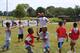 Forte runs a passing drill with the children