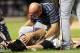 Jul 24, 2013; New York, NY, USA; Atlanta Braves starting pitcher Tim Hudson (15) is checked on by a trainer after being injured in a collision at first base with New York Mets left fielder Eric Young Jr. (not pictured) during the eighth inning at Citi Field. Mandatory Credit: Anthony Gruppuso-USA TODAY Sports