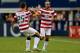 ARLINGTON, TX - JULY 24: Landon Donovan #10 of the United States celebrates his goal with Matt Besler #25 against Honduras during the CONCACAF Gold Cup semifinal match at Cowboys Stadium on July 24, 2013 in Arlington, Texas. (Photo by Ronald Martinez/Getty Images)