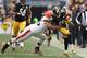 PITTSBURGH, PA - DECEMBER 30: Cortez Allen #28 of the Pittsburgh Steelers is tackled by Alex Mack #55 of the Cleveland Browns after returning a fumble during the game at Heinz Field on December 30, 2012 in Pittsburgh, Pennsylvania. (Photo by Karl Walter/Getty Images)