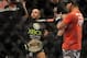 Jan 26, 2013; Chicago, IL, USA; Demetrious Johnson (middle) celebrates after defeating John Dodson (right) during UFC on FOX 6 for the world flyweight championship at the United Center. Mandatory Credit: David Banks-USA TODAY Sports