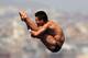 BARCELONA, SPAIN - JULY 27: Qiu Bo of China competes in the Men's 10m Platform Diving Semifinal round on day eight of the 15th FINA World Championships at Piscina Municipal de Montjuic on July 27, 2013 in Barcelona, Spain. (Photo by Clive Rose/Getty Images)
