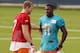Can Dolphins QB Ryan Tannehill (left) quickly get on the same page with dynamic WR Mike Wallace (left)? That's the big question in Dolphins training camp this year.