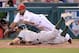 ANAHEIM, CA - JULY 19: Alberto Callaspo #6 of the Los Angeles Angels dives to tag out Eric Sogard #28 of the Oakland Athletics at third base to end the third inning at Angel Stadium of Anaheim on July 19, 2013 in Anaheim, California. (Photo by Harry How/Getty Images)