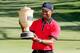 AKRON, OH - AUGUST 04: Tiger Woods holds up the Gary Player Cup trophy after the Final Round of the World Golf Championships-Bridgestone Invitational at Firestone Country Club South Course on August 4, 2013 in Akron, Ohio. Woods won the tournament with a score of -15. (Photo by Gregory Shamus/Getty Images)