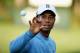 ROCHESTER, NY - AUGUST 06: Tiger Woods of the United States catches a golf ball on the practice range during a practice round prior to the start of the 95th PGA Championship at Oak Hill Country Club on August 6, 2013 in Rochester, New York. (Photo by Scott Halleran/Getty Images)