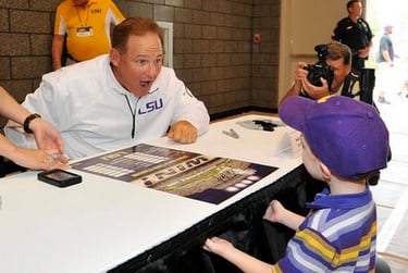 Photo: Les Miles Has Fun With A Little Tigers Supporter On LSU's Fan Day
