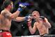 August 4, 2012; Los Angeles, CA, USA; Jamie Varner hits Joe Lauzon during the lightweight match at Staples Center. Mandatory Credit: Gary A. Vasquez-USA TODAY Sports