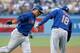 LOS ANGELES, CA - AUGUST 13: Juan Lagares #12 of the New York Mets is greeted by third base coach Tim Teufel #18 as he rounds third after hitting a solo home run against the Los Angeles Dodgers in the first inning at Dodger Stadium on August 13, 2013 in Los Angeles, California. (Photo by Stephen Dunn/Getty Images)