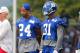 Terrell Thomas and Aaron Ross stand on the sidelines during camp.