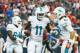 HOUSTON, TX - AUGUST 17: Mike Wallace #11 of the Miami Dolphins celebrates with Brian Hartline #82 after Wallace scored a 9-yard toudhdown in the first half against the Houston Texans during a preseaon game at Reliant Stadium on August 17, 2013 in Houston, Texas. (Photo by Scott Halleran/Getty Images)