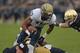 SOUTH BEND, IN - NOVEMBER 03: Devin Street #15 of the Pittsburgh Panthers tries to break away from Bennett Jackson #2 and Manti T'eo #5 of the Notre Dame Fighting Irish at Notre Dame Stadium on November 3, 2012 in South Bend, Indiana. Notre Dame defeated Pittsburgh 29-23 in triple overtime. (Photo by Jonathan Daniel/Getty Images)