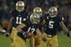 SOUTH BEND, IN - OCTOBER 20: Danny Spond #13 of the Notre Dame Fighting Irish celebrates with teammates including Ishaq Williams #11 and Manti T'eo #5 after intercepting a pass on the next to last play of the game against the BYU Cougars at Notre Dame Stadium on October 20, 2012 in South Bend, Indiana. Notre Dame defeated BYU 17-14. (Photo by Jonathan Daniel/Getty Images)