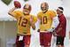 Aug 13, 2013; Richmond, VA, USA; Washington Redskins quarterback Kirk Cousins (12) throws the ball in front of Redskins quarterback Robert Griffin III (10) and Redskins quarterback scotch Matt LaFleur (right) during afternoon practice as part of the 2013 NFL training camp at the Bon Secours Washington Redskins Training Center. Mandatory Credit: Geoff Burke-USA TODAY Sports