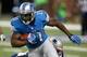 DETROIT, MI - AUGUST 22: Reggie Bush #21 of the Detroit Lions looks to get around the tackle of Stevan Ridley #22 of the New England Patriots during a first quarter run during a pre season game at Ford Field on August 22, 2013 in Detroit, Michigan. (Photo by Gregory Shamus/Getty Images)