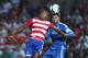GRANADA, SPAIN - AUGUST 26: Hassan Yebda (L) of Granada CF goes for a high ball against Sergio Ramos of Real Madrid CF during the La Liga match between Granada CF and Real Madrid CF at Estadio Nuevo Los Carmenes on August 26, 2013 in Granada, Spain. (Photo by Denis Doyle/Getty Images)