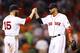 BOSTON, MA - AUGUST 27: Shane Victorino #18 is congratulated by teammate Dustin Pedroia #15 of the Boston Red Sox following their 13-2 win against the Baltimore Orioles during the game on August 27, 2013 at Fenway Park in Boston, Massachusetts. (Photo by Jared Wickerham/Getty Images)
