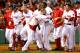 BOSTON, MA - JULY 22: Mike Napoli #12 of the Boston Red Sox is congratulated by teammates at home plate after hitting a walk-off home run in the 11th inning against the New York Yankees during the game on July 22, 2013 at Fenway Park in Boston, Massachusetts. (Photo by Jared Wickerham/Getty Images)