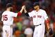 BOSTON, MA - AUGUST 27: Shane Victorino #18 is congratulated by teammate Dustin Pedroia #15 of the Boston Red Sox following their 13-2 win against the Baltimore Orioles during the game on August 27, 2013 at Fenway Park in Boston, Massachusetts. (Photo by Jared Wickerham/Getty Images)