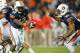 AUBURN, AL - NOVEMBER 10: Quarterback Jonathan Wallace #12 of the Auburn Tigers prepares to hand the ball off to running back Tre Mason #21 of the Auburn Tigers during their game against the Georgia Bulldogs on November 10, 2012 at Jordan-Hare Stadium in Auburn, Alabama. Georgia defeated Auburn 38-0 and clinched the SEC East division. (Photo by Michael Chang/Getty Images)