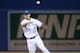 TORONTO, CANADA - AUGUST 15: Brett Lawrie #13 of the Toronto Blue Jays throws out the baserunner in the fifth inning during MLB game action against the Boston Red Sox on August 15, 2013 at Rogers Centre in Toronto, Ontario, Canada. (Photo by Tom Szczerbowski/Getty Images)