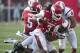 Aug 31, 2013; Fayetteville, AR, USA; Arkansas Razorback running back Alex Collins (3) is brought down Louisiana Ragin' Cajuns linebacker Chris Hill (39) and safety Trevence Patt (4) during the second half of a game at Donald W. Reynolds Razorback Stadium. Arkansas defeated Louisiana 34-14. Mandatory Credit: Beth Hall-USA TODAY Sports
