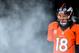 DENVER, CO - JANUARY 12: Peyton Manning #18 of the Denver Broncos looks through smoke as he waits in the tunnel during player introductions against the Baltimore Ravens during the AFC Divisional Playoff Game at Sports Authority Field at Mile High on January 12, 2013 in Denver, Colorado. (Photo by Dustin Bradford/Getty Images)
