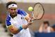 NEW YORK, NY - SEPTEMBER 02: David Ferrer of Spain plays a backhand to Janko Tipsarevic of Serbia during their fourth round men's singles match on Day Eight of the 2013 US Open at USTA Billie Jean King National Tennis Center on September 2, 2013 in the Flushing neighborhood of the Queens borough of New York City. (Photo by Clive Brunskill/Getty Images)