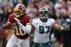 WASHINGTON, DC - NOVEMBER 18: Quarterback Robert Griffin III #10 of the Washington Redskins eludes the tackle Cullen Jenkins #97 of the Philadelphia Eagles at FedEx Field on November 18, 2012 in Washington, DC. (Photo by Rob Carr/Getty Images)