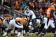 DENVER, CO - JANUARY 12: Joe Flacco #5 of the Baltimore Ravens calls signals out as he stands under center at the line of scrimmage against the Denver Broncos during the AFC Divisional Playoff Game at Sports Authority Field at Mile High on January 12, 2013 in Denver, Colorado. The Ravens won 38-35 in 2 overtimes. (Photo by Dustin Bradford/Getty Images)