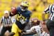 ANN ARBOR, MI - AUGUST 31: Devin Gardner #12 of the Michigan Wolverines runs for a first quarter touchdown past Louis Palmer #56 of the Central Michigan Chippewas at Michigan Stadium on August 31, 2013 in Ann Arbor, Michigan. (Photo by Gregory Shamus/Getty Images)