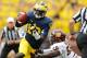 ANN ARBOR, MI - AUGUST 31: Devin Gardner #12 of the Michigan Wolverines runs for a first quarter touchdown past Louis Palmer #56 of the Central Michigan Chippewas at Michigan Stadium on August 31, 2013 in Ann Arbor, Michigan. (Photo by Gregory Shamus/Getty Images)