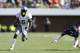 CHARLOTTESVILLE, VA - SEPTEMBER 7: De'Anthony Thomas #6 of the Oregon Ducks breaks a tackle on his way to rushing for a 40-yard touchdown in the first quarter of the game against the Virginia Cavaliers at Scott Stadium on September 7, 2013 in Charlottesville, Virginia. (Photo by Joe Robbins/Getty Images)