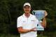 NORTON, MA - SEPTEMBER 02: Henrik Stenson of Sweden is presented with the winner's trophy after winning the Deutsche Bank Championship at TPC Boston on September 2, 2013 in Norton, Massachusetts. (Photo by Jim Rogash/Getty Images)