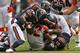 CHICAGO, IL - SEPTEMBER 08: BenJarvus Green-Ellis #42 of the Cincinnati Bengals is gang-tackled by members the Chicago Bears including Tim Jennings #26 and Major Wright #21 at Soldier Field on September 8, 2013 in Chicago, Illinois. The Bears defeated the Bengals 24-21. (Photo by Jonathan Daniel/Getty Images)
