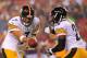 Aug 19, 2013; Landover, MD, USA; Pittsburgh Steelers quarterback Ben Roethlisberger (7) hands the ball off to Steelers running back Le'Veon Bell (26) against the Washington Redskins at FedEx Field. Mandatory Credit: Geoff Burke-USA TODAY Sports