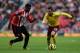 SUNDERLAND, ENGLAND - FEBRUARY 09: Santi Carzola of Arsenal attempts to move away from Alfred N'Diaye of Sunderland during the Barclays Premier League match between Sunderland and Arsenal at the Stadium of Light on February 9, 2013 in Sunderland, England. (Photo by Clive Brunskill/Getty Images)