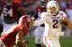 November 10, 2012; Tuscaloosa, AL, USA; Texas A&M Aggies quarterback Johnny Manziel (2) stiff arms Alabama Crimson Tide defensive back Deion Belue (13) during the first quarter at Bryant Denny Stadium. Mandatory Credit: John David Mercer-USA TODAY Sports