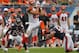 Sep 8, 2013; Chicago, IL, USA; Cincinnati Bengals tight end Tyler Eifert (center) makes a catch between Chicago Bears cornerback Tim Jennings (left) and Bears outside linebacker Lance Briggs (right) during the second half at Soldier Field. Chicago won 24-21. Mandatory Credit: Dennis Wierzbicki-USA TODAY Sports