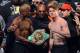 LAS VEGAS, NV - SEPTEMBER 13: CEO of Mayweather Promotions Leonard Ellerbe (C) looks on as boxer Floyd Mayweather Jr. (L) tries to get boxer Canelo Alvarez (R) to hold a WBC belt as they pose during the official weigh-in for their bout at the MGM Grand Garden Arena on September 13, 2013 in Las Vegas, Nevada. The fighters will meet in a WBC/WBA 154-pound title fight on September 14 in Las Vegas. (Photo by Ethan Miller/Getty Images)