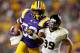 BATON ROUGE, LA - SEPTEMBER 15: Jeremy Hill #33 of the LSU Tigers avoids a tackle by Matthew Willis #39 of the Idaho Vandals at Tiger Stadium on September 15, 2012 in Baton Rouge, Louisiana. LSU Tigers defeated the Idaho Vandals 63-14. (Photo by Chris Graythen/Getty Images)